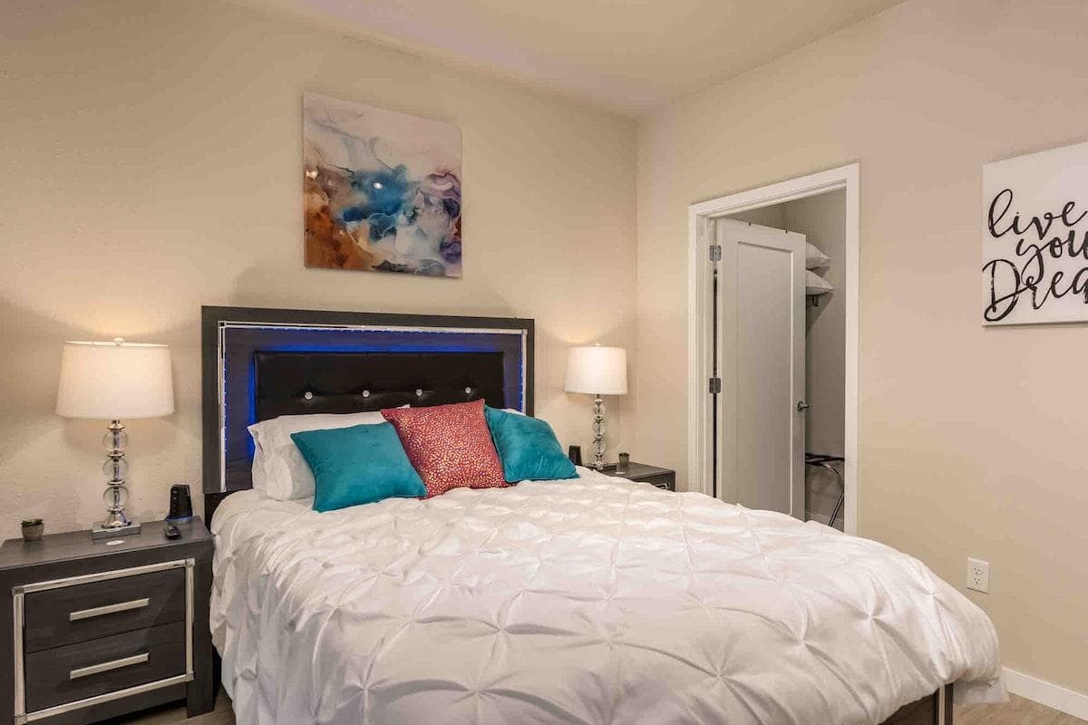Bedroom with queen mattress and walk-in closet.