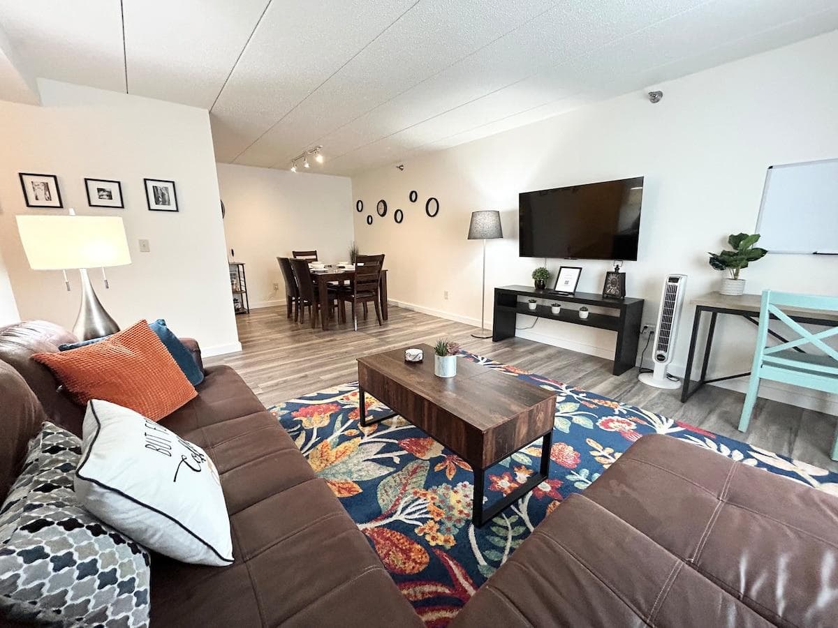 Living room area, TCL - 55" Class S5-Series 4K UHD HDR LED Smart Google TV, sectional sofa, coffee table, tower fan.