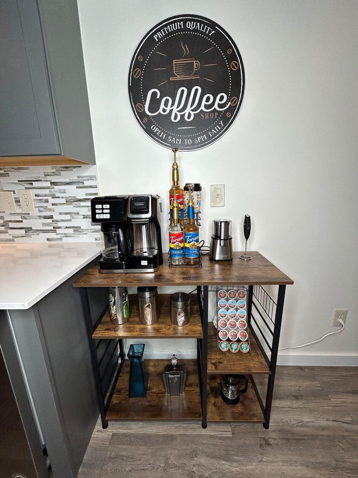 Coffee Bar, 12 cup drip coffee maker, single serve coffee maker, french press, flavored coffee syrups, coffee bean grinder, frothier, coffee creamer, tea bags, sugar, travel coffee cups.