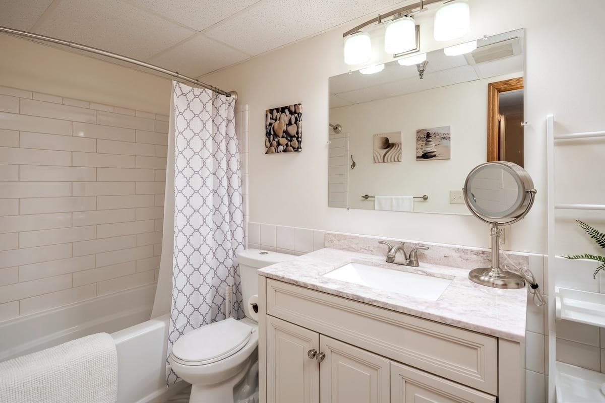 Updated bathroom with new vanity, tiled shower and full bath tub. 